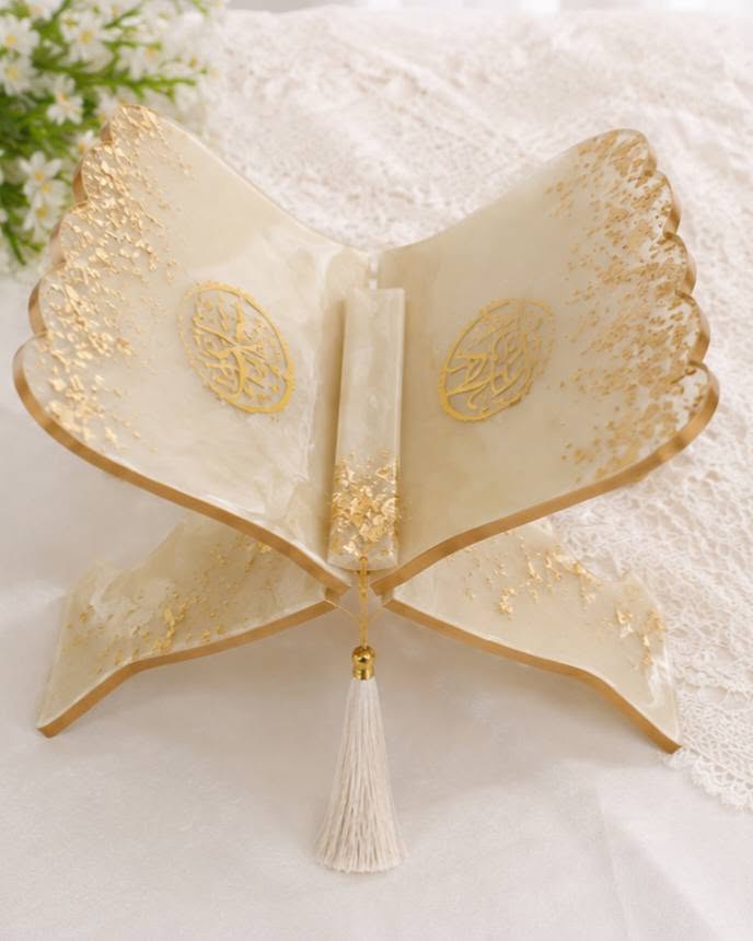 Ivory and gold resin Quran rehal with gold leaf and a cream tassel