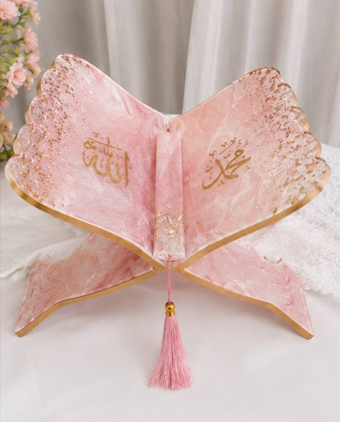 Blush pink marbled resin Quran rehal with gold calligraphy and a pink tassel